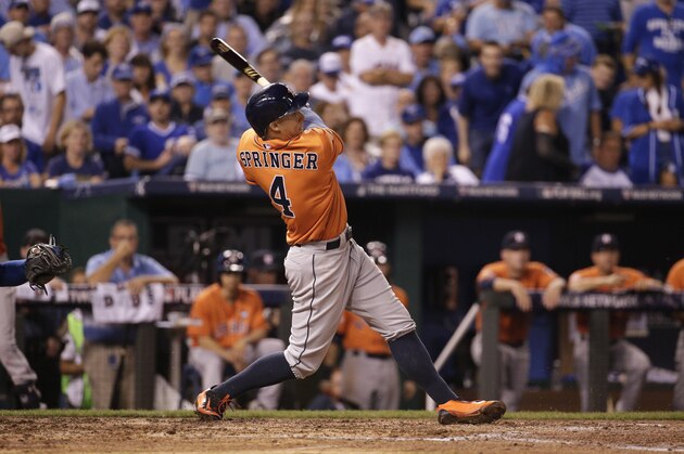 Houston Astros' George Springer hits a solo home run during the fifth inning in Game 1 of baseball's American League Division Series against the Kansas City Royals, Thursday, Oct. 8, 2015, in Kansas City, Mo. (AP Photo/Charlie Riedel)