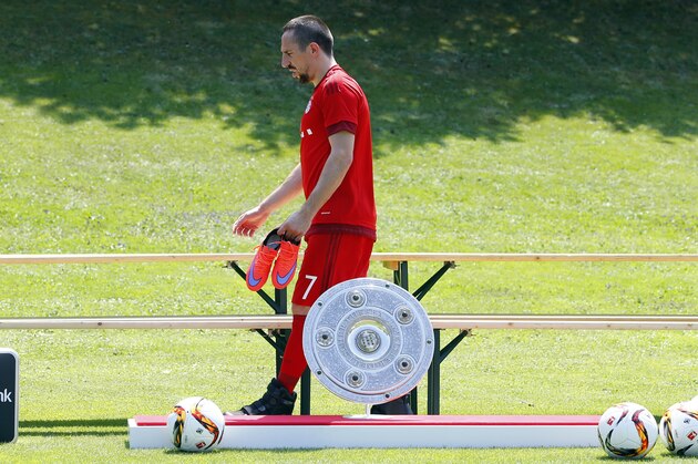 Bayern's Franck Ribery from France walks past the German soccer league trophy prior to an official photo shooting for the upcoming German first division Bundesliga soccer season in Munich, Germany, Thursday, July 16, 2015. (AP Photo/Matthias Schrader)