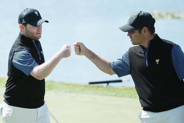 INCHEON CITY, SOUTH KOREA - OCTOBER 09:  Branden Grace (L)  and Louis Oosthuizen of South Africa and the International team celebrate a birdie putt on the ninth green during the Friday four-ball matches at The Presidents Cup at Jack Nicklaus Golf Club Korea on October 9, 2015 in Songdo IBD, Incheon City, South Korea  (Photo by Scott Halleran/Getty Images)