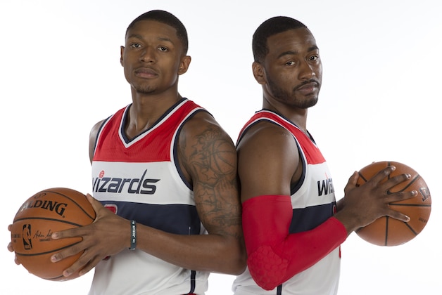 Washington Wizards guard Bradley Beal (3), left, and Washington Wizards guard John Wall (2) pose for photographs during NBA basketball media day at the Verizon Center in Washington, Monday, Sept. 29, 2014. (AP Photo/Carolyn Kaster)