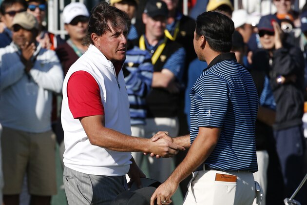 United States' Phil Mickelson, left, congratulates International team player Jason Day of Australia after their four ball match at the Presidents Cup golf tournament at the Jack Nicklaus Golf Club Korea, in Incheon, South Korea, Friday, Oct. 9, 2015.(AP Photo/Lee Jin-man)