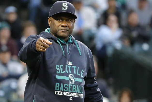 Seattle Mariners manager Lloyd McClendon points towards first base while questioning an umpire's call in the first inning of a baseball game against the Oakland Athletics, Saturday, Oct. 3, 2015, in Seattle. (AP Photo/Ted S. Warren)