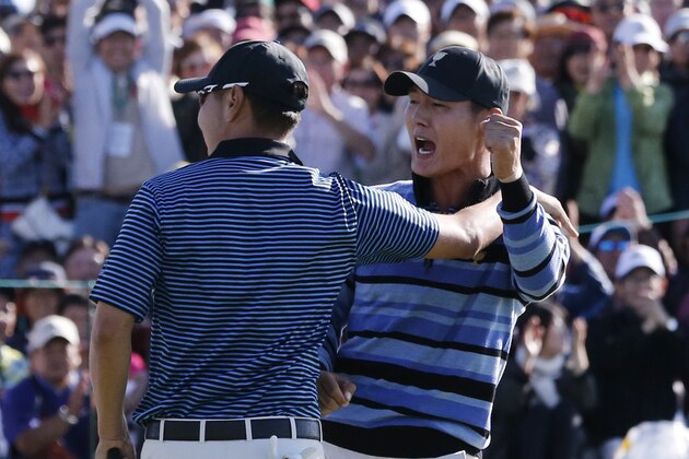 International team player Danny Lee, right, of New Zealand celebrates with playing partner Sangmoon Bae of South Korea on the 18th green after winning their four ball match at the Presidents Cup golf tournament at the Jack Nicklaus Golf Club Korea, in Incheon, South Korea, Friday, Oct. 9, 2015.(AP Photo/Lee Jin-man)