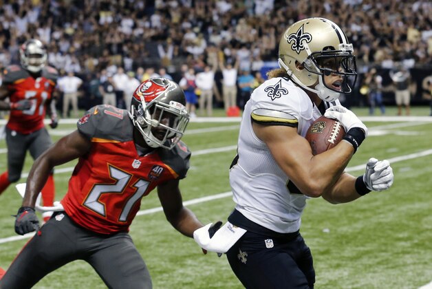 New Orleans Saints wide receiver Willie Snead (83) scores on a touchdown reception in front of Tampa Bay Buccaneers cornerback Alterraun Verner (21) in the second half of an NFL football game in New Orleans, Sunday, Sept. 20, 2015. (AP Photo/Bill Haber)