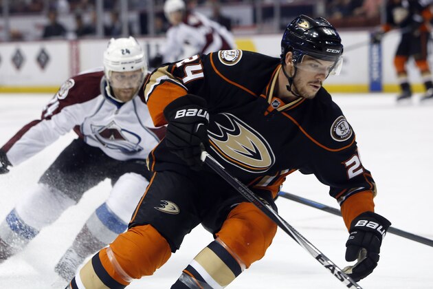 Anaheim Ducks defenseman Simon Despres, right, controls the puck against Colorado Avalanche center Marc-Andre Cliche during the first period  of an NHL hockey game in Anaheim, Calif., Friday, April 3, 2015. (AP Photo/Christine Cotter)