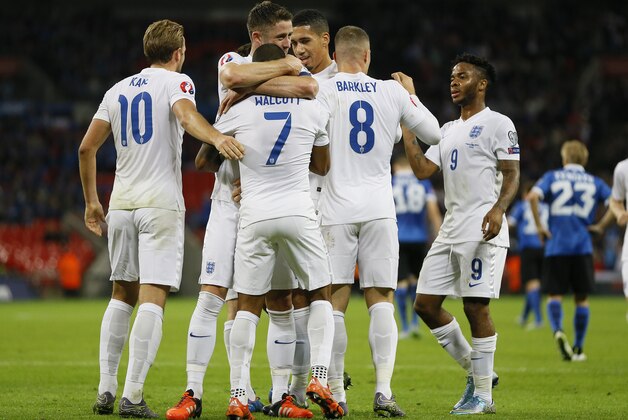 England’s Theo Walcott, center, celebrates with teammates after he scored a goal during the Euro 2016 Group E qualifying soccer match between England and Estonia at Wembley stadium in London, Friday, Oct. 9, 2015. (AP Photo/Kirsty Wigglesworth)