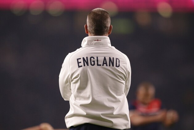 England’s coach Stuart Lancaster observes his players warm-up before the Rugby World Cup Pool A match between England and Australia at Twickenham stadium in London, Saturday, Oct. 3, 2015. (AP Photo/Matt Dunham)