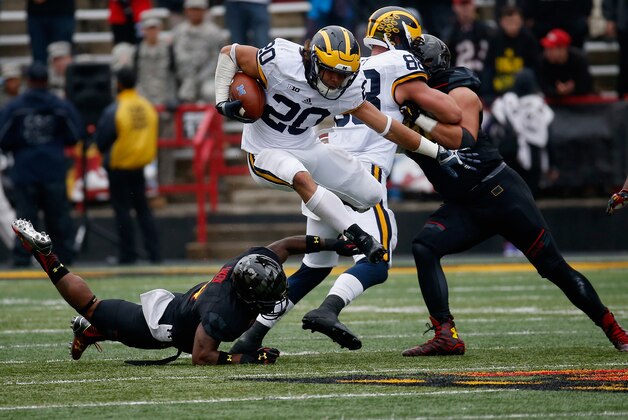 COLLEGE PARK, MD - OCTOBER 03:  Drake Johnson #20 of the Michigan Wolverines jumps over William Likely #4 of the Maryland Terrapins while carrying the ball in the second half of the Wolverines 28-0 win at Byrd Stadium on October 3, 2015 in College Park, Maryland.  (Photo by Rob Carr/Getty Images)