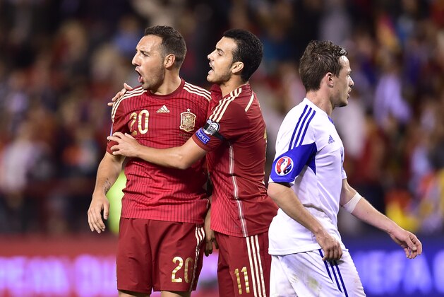 Spain's Santi Cazorla, left, celebrates his goal with teammate Pedro Rodriguez, center,  during their Euro 2016 qualifying soccer match, Group C, between Spain and Luxembourg, at Las Gaunas stadium in Logrono, northern Spain, Friday, Oct. 9, 2015. (AP Photo/Alvaro Barrientos)