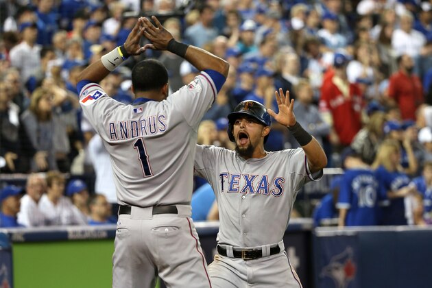 TORONTO, ON - OCTOBER 09: Rougned Odor #12 of the Texas Rangers celebrates scoring the go ahead run in the 14th inning with Elvis Andrus #1 against the Toronto Blue Jays during game two of the American League Division Series at Rogers Centre on October 9, 2015 in Toronto, Canada.  (Photo by Tom Szczerbowski/Getty Images)