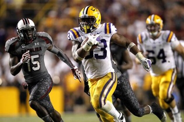 LSU running back Jeremy Hill (33) carries for a 50-yard touchdown as South Carolina cornerback Jimmy Legree (15) pursues during the second half of an NCAA college football game in Baton Rouge, La., Saturday, Oct. 13, 2012. LSU won 23-21. (AP Photo/Gerald Herbert)