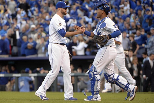 Oct 9, 2015; Kansas City, MO, USA; Kansas City Royals relief pitcher Wade Davis (left) celebrates with catcher Salvador Perez (right) after defeating the Houston Astros in game two of the ALDS at Kauffman Stadium. Mandatory Credit: John Rieger-USA TODAY Sports