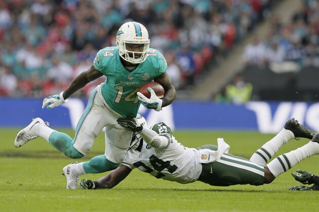 Miami Dolphins' Jarvis Landry, left, breaks the challenge from New York Jets' Darrelle Revis during the NFL football game between the New York Jets and the Miami Dolphins and at Wembley stadium in London, Sunday, Oct. 4, 2015. (AP Photo/Tim Ireland)