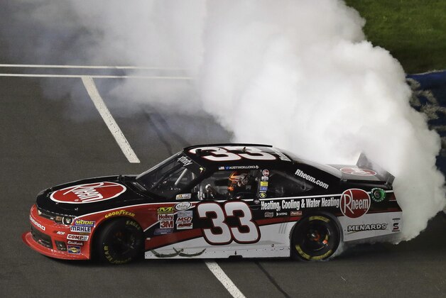 Austin Dillon (33) does a burnout after winning the NASCAR Xfinity series auto race at Charlotte Motor Speedway in Concord, N.C., Friday, Oct. 9, 2015. (AP Photo/Gerry Broome)