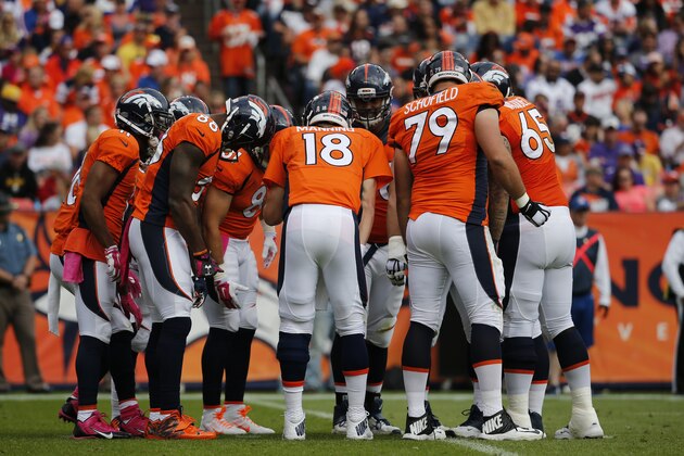 Denver Broncos quarterback Peyton Manning huddles the offense during an NFL football game between the Denver Broncos and the Minnesota Vikings Sunday, Oct. 4, 2015, in Denver. (AP Photo/Jack Dempsey)
