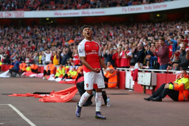 LONDON, ENGLAND - OCTOBER 04:  Having jumped over the led boards, Alex Oxlade-Chamberlain of Arsenal reacts after missing a chance during the Barclays Premier League match between Arsenal and Manchester United at the Emirates Stadium on October 04, 2015 in London, United Kingdom.  (Photo by Catherine Ivill - AMA/Getty Images)