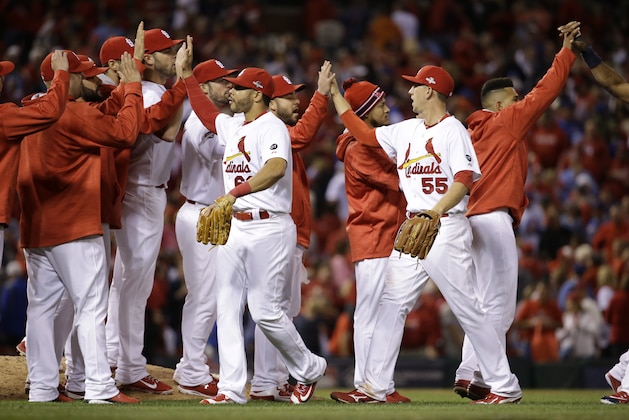 St. Louis Cardinals' Stephen Piscotty (55) and Tommy Pham (60) celebrate with teammates after the Cardinals defeated the Chicago Cubs, 4-0, in  Game 1 in baseball's National League Division Series Friday, Oct. 9, 2015, in St. Louis. (AP Photo/Jeff Roberson)