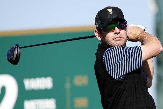 International team player Louis Oosthuizen of South Africa watches his tee shot on the second hole during his four ball match at the Presidents Cup golf tournament at the Jack Nicklaus Golf Club Korea, in Incheon, South Korea, Friday, Oct. 9, 2015.(AP Photo/Lee Jin-man)