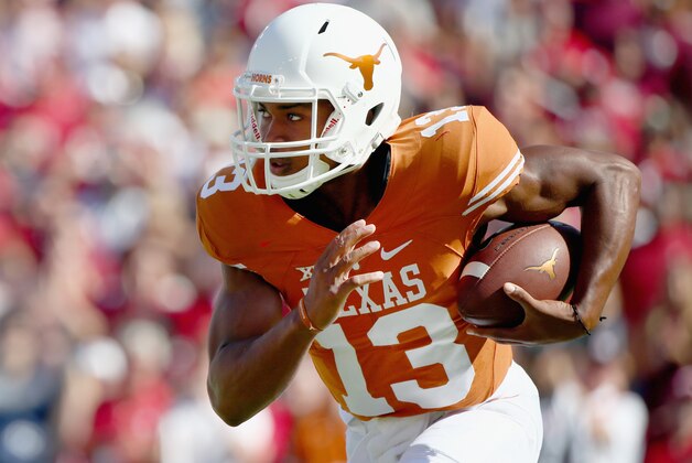 DALLAS, TX - OCTOBER 10:  Jerrod Heard #13 of the Texas Longhorns carries the ball against the Oklahoma Sooners in the first quarter during the AT&T Red River Showdown at the Cotton Bowl on October 10, 2015 in Dallas, Texas.  (Photo by Tom Pennington/Getty Images)