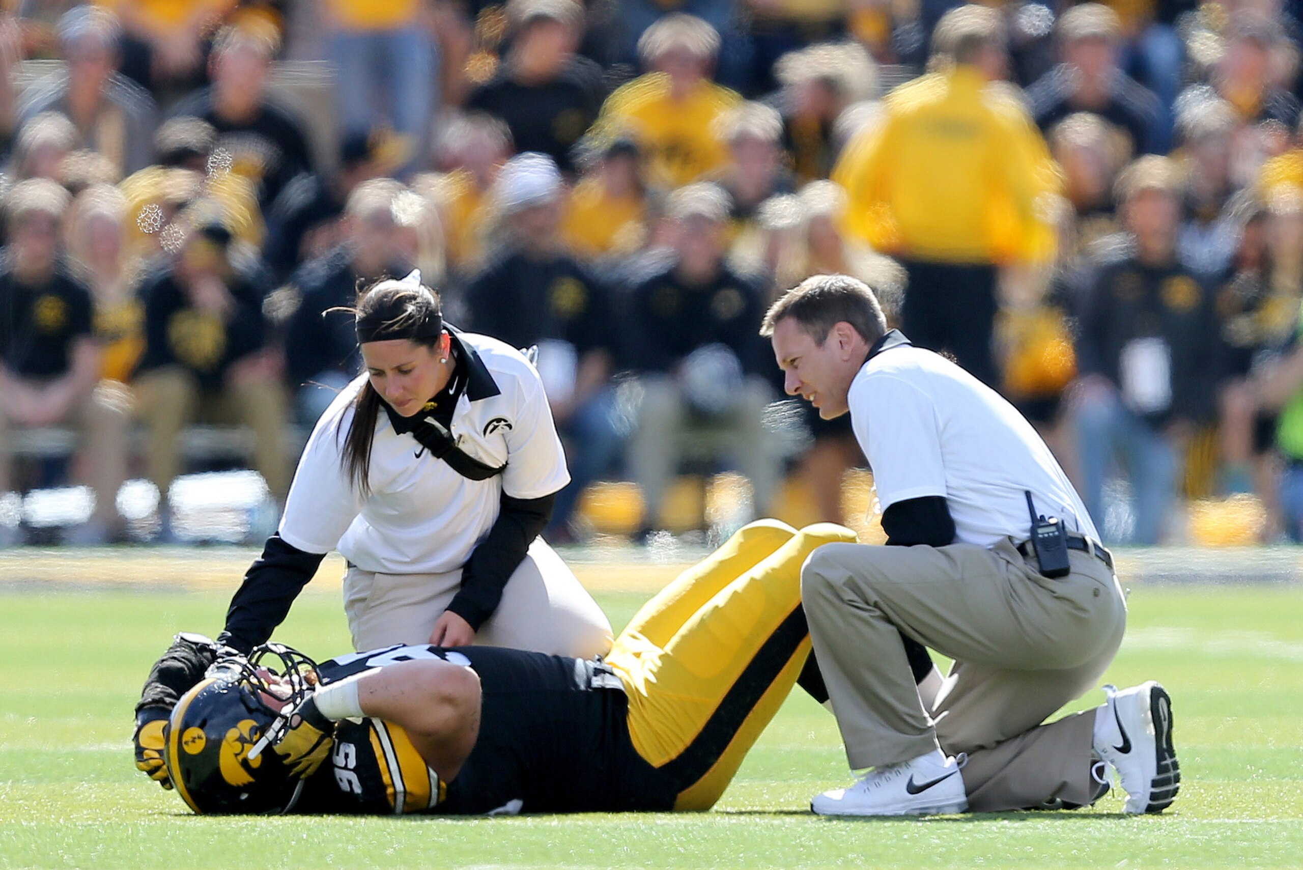 Iowa trainers attend to defensive lineman Drew Ott after he was injured during the second half of an NCAA college football game against Illinois, Saturday, Oct. 10, 2015, in Iowa City, Iowa. (AP Photo/Justin Hayworth)