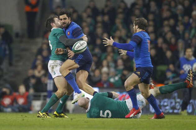 France's Yoann Huget, left, is tackled by Ireland's Conor Murray and Paul O'Connell, during their rugby union 6 nations match at the Aviva stadium, Dublin, Ireland, Saturday, Feb. 14, 2015.  (AP Photo/Peter Morrison)
