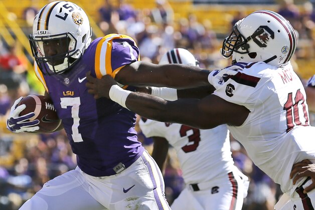 LSU running back Leonard Fournette (7) stiff arms South Carolina linebacker Skai Moore (10) during the first half of an NCAA college football game in Baton Rouge, La., Saturday, Oct. 10, 2015. (AP Photo/Jonathan Bachman)