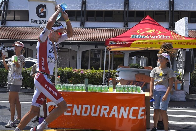 Jan Frodeno, of Germany, pours water on his head during the marathon portion of the Ironman World Championship Triathlon, Saturday, Oct. 10, 2015, in Kailua-Kona, Hawaii. (AP Photo/Mark J. Terrill)