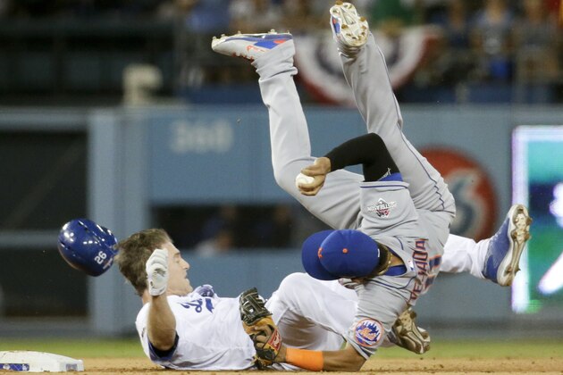New York Mets shortstop Ruben Tejada, goes over the top of Los Angeles Dodgers' Chase Utley who broke up a double play during the seventh inning in Game 2 of baseball's National League Division Series, Saturday, Oct. 10, 2015 in Los Angeles.  (AP Photo/Gregory Bull)
