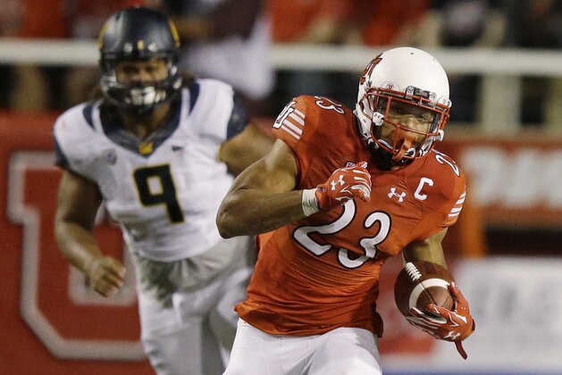 Utah running back Devontae Booker (23) carries the ball while being pursued by California defensive tackle James Looney (9) in the first half during an NCAA college football game Saturday, Oct. 10, 2015, in Salt Lake City. (AP Photo/Rick Bowmer)