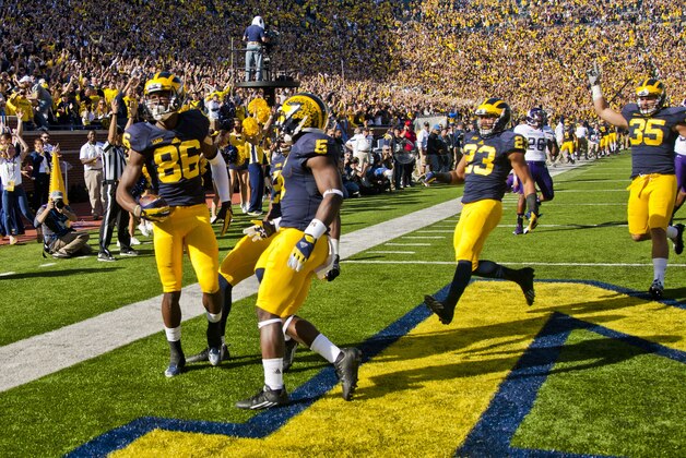 Michigan wide receiver Jehu Chesson (86) celebrates his touchdown with defensive back Jabrill Peppers (5) on a kickoff return in the first quarter of an NCAA college football game against Northwestern in Ann Arbor, Mich., Saturday, Oct. 10, 2015. (AP Photo/Tony Ding)