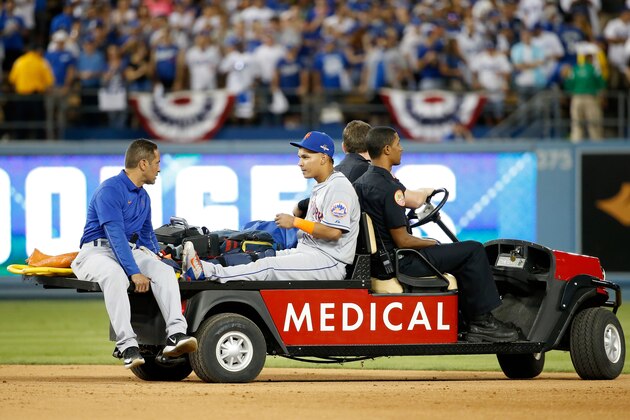 LOS ANGELES, CA - OCTOBER 10:  Ruben Tejada #11 of the New York Mets is carted off the field after sustaining an injury in the seventh inning on slide by Chase Utley #26 of the Los Angeles Dodgers in game two of the National League Division Series at Dodger Stadium on October 10, 2015 in Los Angeles, California.  (Photo by Sean M. Haffey/Getty Images)