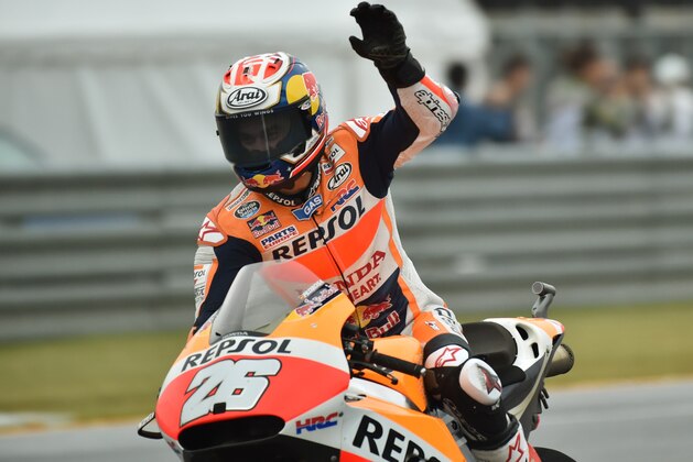 Repsol Honda Team rider Dani Pedrosa of Spain waves to the audience as he celebrates his win at the MotoGP Japanese Grand Prix in Motegi, Tochigi prefecture on October 11, 2015.     AFP PHOTO / KAZUHIRO NOGI        (Photo credit should read KAZUHIRO NOGI/AFP/Getty Images)