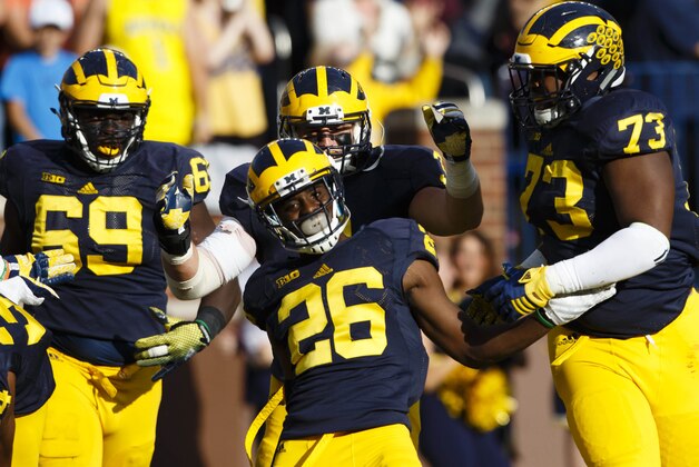Oct 10, 2015; Ann Arbor, MI, USA; Michigan Wolverines cornerback Jourdan Lewis (26) celebrates with teammates after he scores a touchdown on an interception in the second quarter against the Northwestern Wildcats at Michigan Stadium. Mandatory Credit: Rick Osentoski-USA TODAY Sports