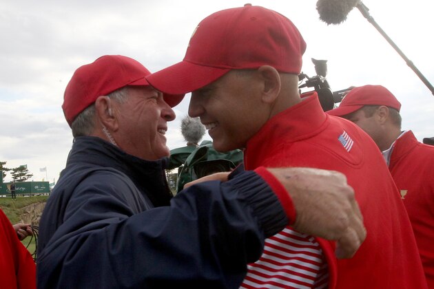 US team captain Jay Haas, left, embraces his son Bill after he won his singles match to defeat the International team to help retain the Presidents Cup golf at the Jack Nicklaus Golf Club Korea, in Incheon, South Korea, Sunday, Oct. 11, 2015.(AP Photo/Ahn Young-joon)