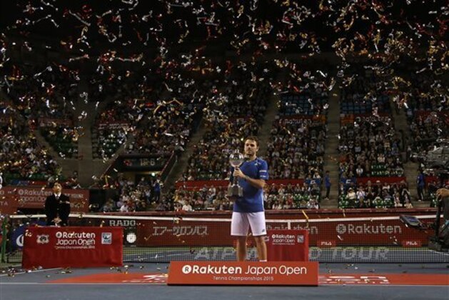 Stan Wawrinka of Switzerland  holds up the championship trophy after defeating Benoit Paire of France in the championship match of the Japan Open men’s tennis tournament in Tokyo, Sunday, Oct. 11, 2015. (AP Photo/Eugene Hoshiko)