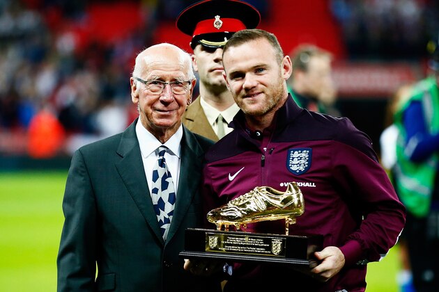LONDON, ENGLAND - OCTOBER 09:  Wayne Rooney of England is presented with the Golden Boot by Sir Bobby Charlton after breaking his record of 49 goals prior to the UEFA EURO 2016 Group E qualifying match between England and Estonia at Wembley on October 9, 2015 in London, United Kingdom.  (Photo by Clive Rose/Getty Images)