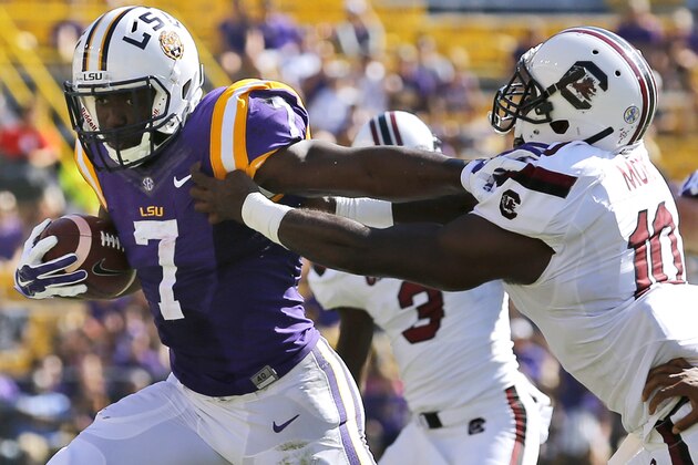 LSU running back Leonard Fournette (7) stiff arms South Carolina linebacker Skai Moore (10) during the first half of an NCAA college football game in Baton Rouge, La., Saturday, Oct. 10, 2015. (AP Photo/Jonathan Bachman)