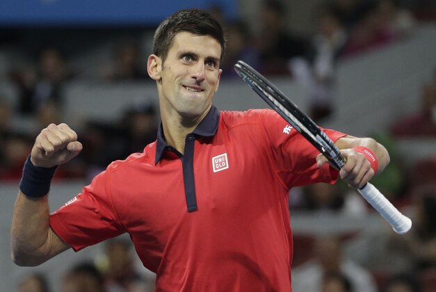 Novak Djokovic of Serbia jubilates after winning a break point against David Ferrer of Spain during their men's singles semifinals match of the China Open tennis tournament at the National Tennis Stadium in Beijing, Saturday, Oct. 10, 2015. (AP Photo/Andy Wong)
