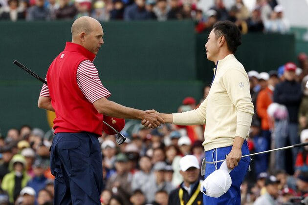 International team player Sangmoon Bae, right, of South Korea congratulates United States' Bill Haas on the 18th green following their singles match at the Presidents Cup golf tournament at the Jack Nicklaus Golf Club Korea, in Incheon, South Korea, Sunday, Oct. 11, 2015.(AP Photo/Lee Jin-man)