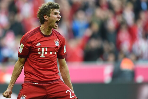 Bayern's Thomas Mueller celebrates after scoring his opening goal during the Bundesliga soccer match between FC Bayern Munich and Borussia Dortmund at the Allianz Arena stadium in Munich, Germany, Sunday, Oct. 4, 2015. (Andreas Gebert/dpa via AP)