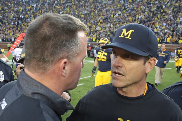 ANN ARBOR, MI - OCTOBER 10: Northwestern Wildcats head coach Pat Fitzgerald and Michigan head coach Jim Harbaugh meet after the game on October 10, 2015 at Michigan Stadium in Ann Arbor, Michigan. The Wolverines defeated the Wildcats 38-0. (Photo by Leon Halip/Getty Images)