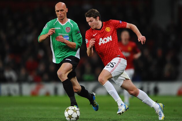 MANCHESTER, ENGLAND - DECEMBER 05:  Nick Powell of Manchester United competes with Gabriel Muresan of CFR 1907 Cluj during the UEFA Champions League Group H match between Manchester United and CFR 1907 Cluj at Old Trafford on December 5, 2012 in Manchester, England.  (Photo by Laurence Griffiths/Getty Images)