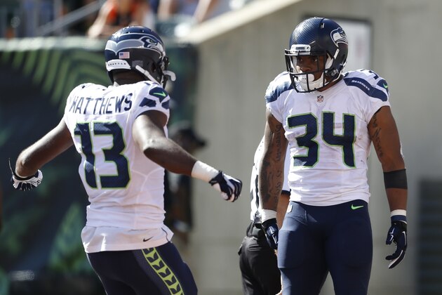 Seattle Seahawks running back Thomas Rawls (34) celebrates his touchdown with wide receiver Chris Matthews (13) in the second half of an NFL football game against the Cincinnati Bengals, Sunday, Oct. 11, 2015, in Cincinnati. (AP Photo/Gary Landers)