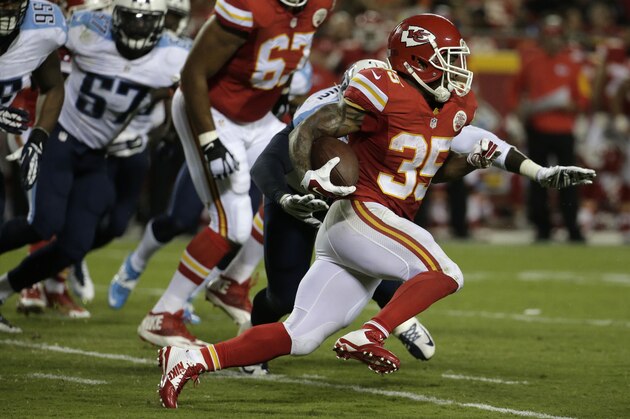 Kansas City Chiefs running back Charcandrick West (35) runs past Tennessee Titans linebacker Jonathan Massaquoi during the second half of a preseason NFL football game at Arrowhead Stadium in Kansas City, Mo., Friday, Aug. 28, 2015. (AP Photo/Charlie Riedel)