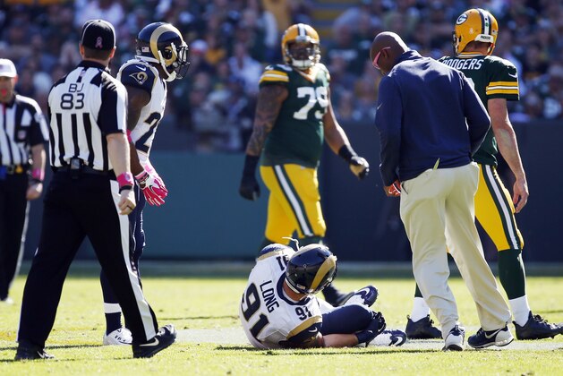 St. Louis Rams' Chris Long is hurt during the first half an NFL football game against the Green Bay Packers Sunday, Oct. 11, 2015, in Green Bay, Wis. (AP Photo/Mike Roemer)