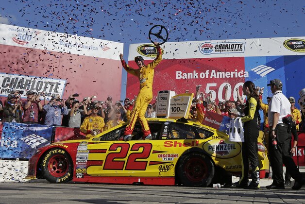Joey Logano celebrates in Victory Lane after winning the NASCAR Sprint Cup series auto race at Charlotte Motor Speedway in Concord, N.C., Sunday, Oct. 11, 2015. (AP Photo/Chuck Burton)