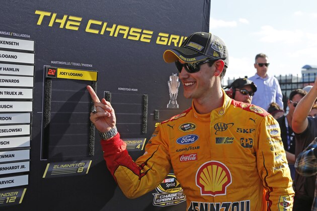 Joey Logano points to his name on the playoff board after winning the NASCAR Sprint Cup series auto race at Charlotte Motor Speedway in Concord, N.C., Sunday, Oct. 11, 2015. (AP Photo/Terry Renna)