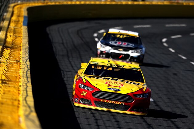 CHARLOTTE, NC - OCTOBER 11:  Joey Logano, driver of the #22 Shell Pennzoil Ford, leads Kevin Harvick, driver of the #4 Jimmy John's/Budweiser Chevrolet, during the NASCAR Sprint Cup Series Bank of America 500 at Charlotte Motor Speedway on October 11, 2015 in Charlotte, North Carolina.  (Photo by Sean Gardner/Getty Images)