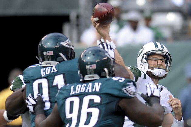 New York Jets quarterback Ryan Fitzpatrick (14) passes the ball as Philadelphia Eagles defensive end Fletcher Cox (91) and nose tackle Bennie Logan (96) close in during the first quarter of an NFL football game, Sunday, Sept. 27, 2015, in East Rutherford, N.J. (AP Photo/Bill Kostroun)