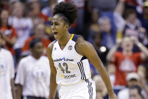 Indiana Fever's Shenise Johnson celebrates in the second half of Game 4 of the WNBA Finals basketball series against the Minnesota Lynx, in Indianapolis, Sunday, Oct. 11, 2015.  (AP Photo/Michael Conroy)